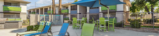 our apartments have a patio with chairs and umbrellas